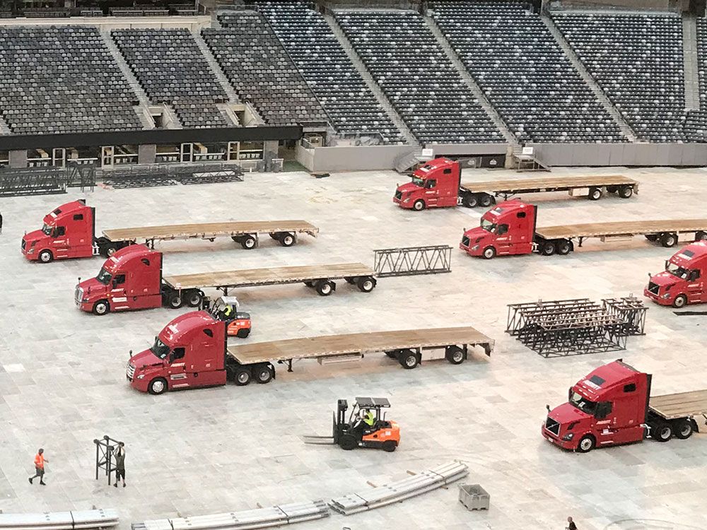 On Tour Logistics flatbed fleet delivering world's largest stage to Nashville Nissan Stadium for Ed Sheeran North America Tour in 2018.
